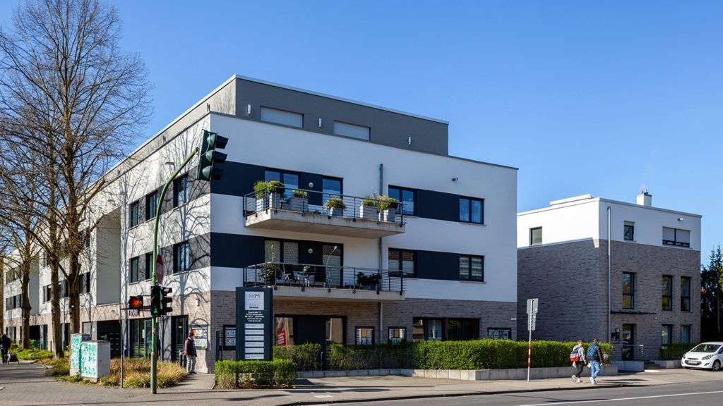 SKANDELLA-residential-office-complex-leverkusen-high-end-plaster-stone-side-view-pedestrian-view